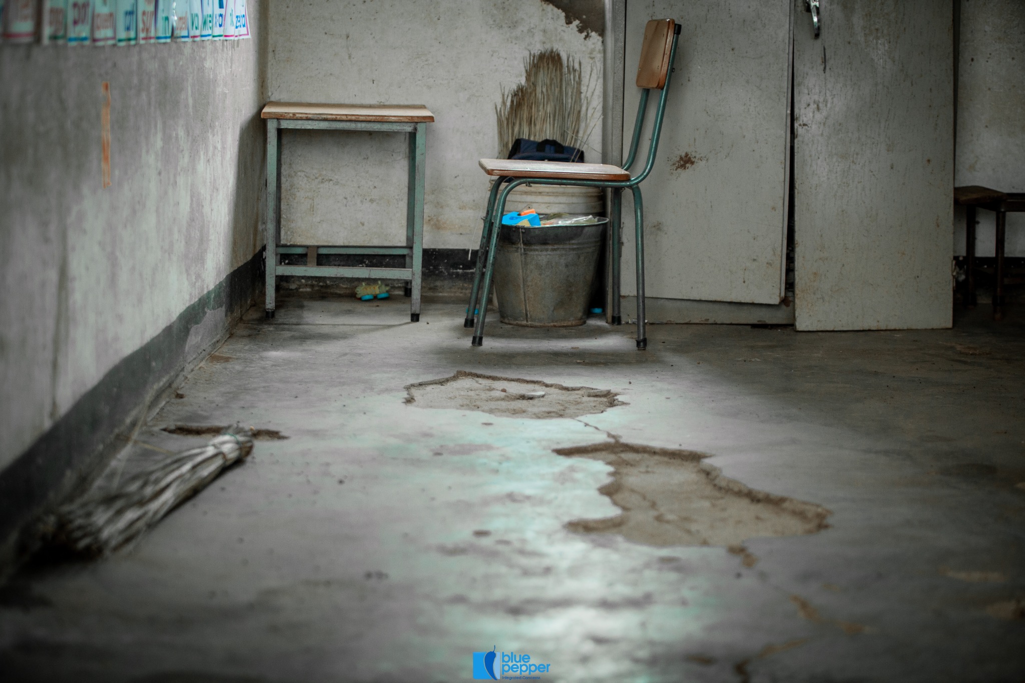Deteriorated floor surfaces inside a Seboza classroom