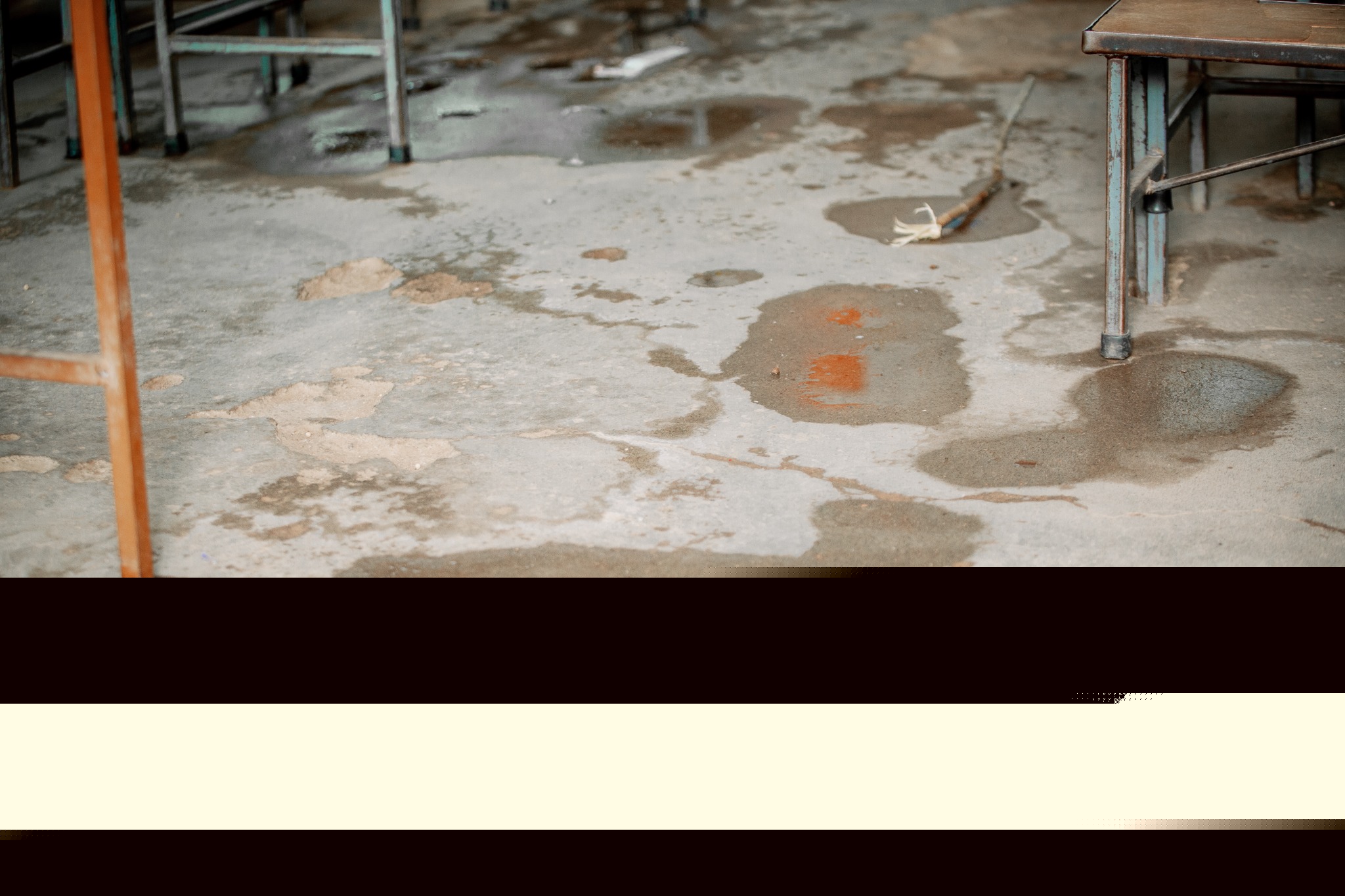 Visible water pooling and damp patches on a Seboza classroom floor