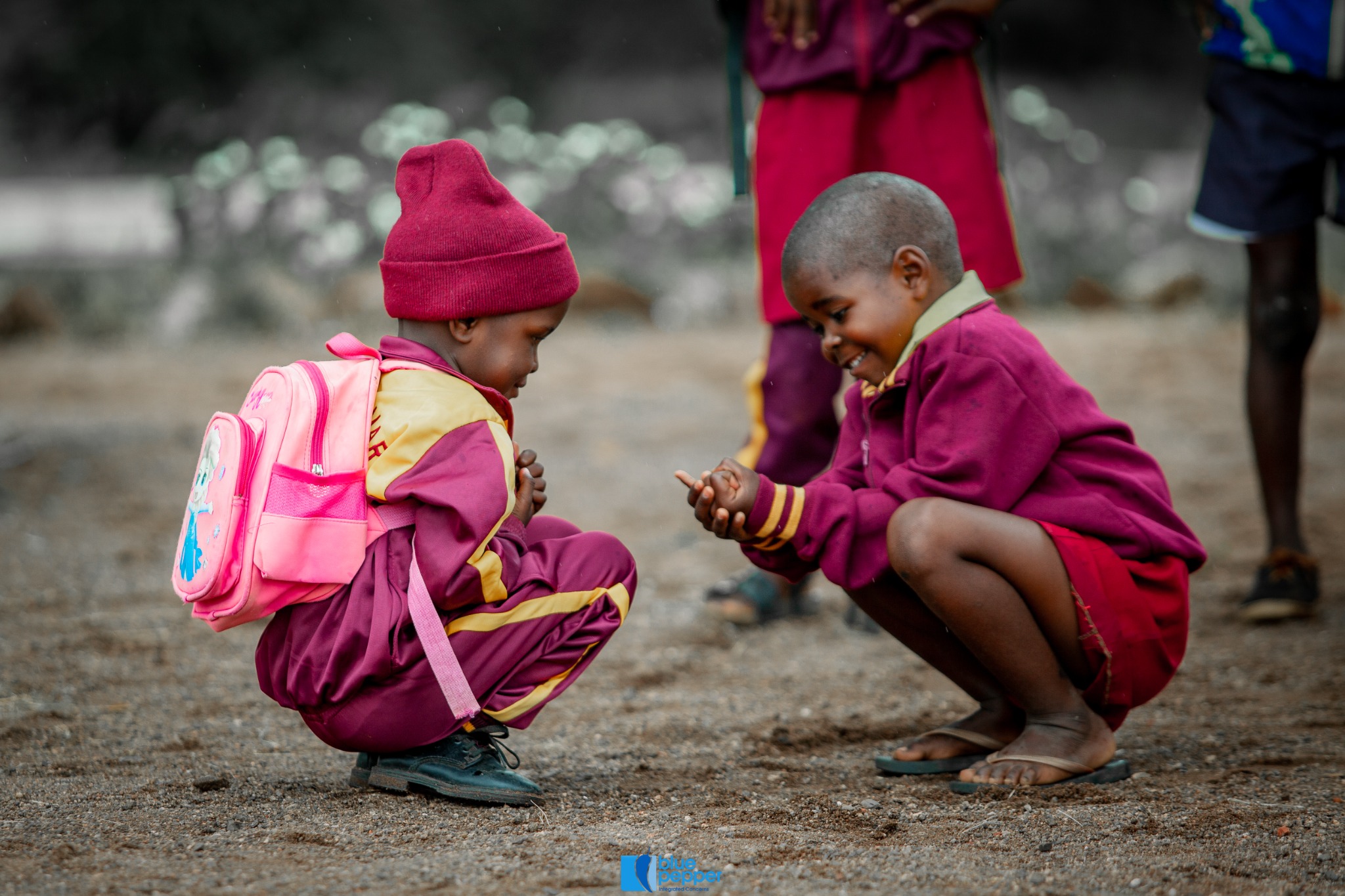 Two Seboza learners playing together in the school grounds